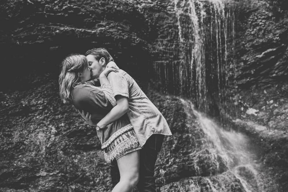 couple dip shot in front of waterfall