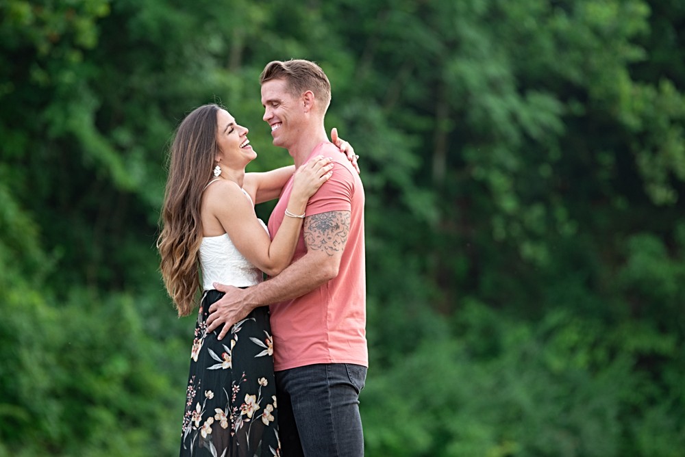 laughing with green trees in background