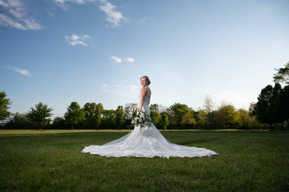 dramatic bridal portrait with blue skies