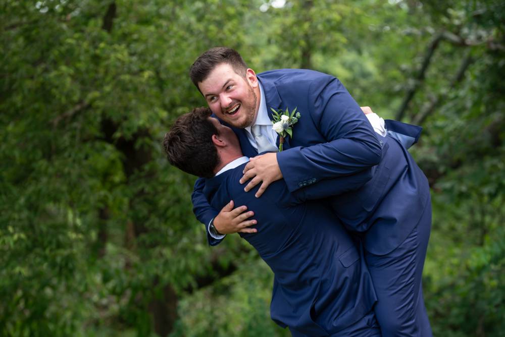 groom behing picked up