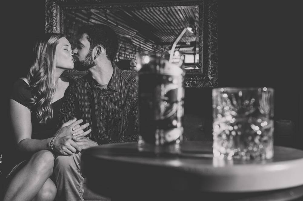 couple sitting on couch in whiskey bar