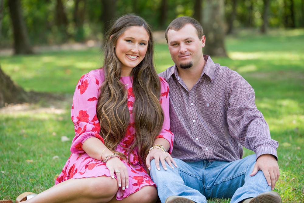 couple sitting in grass at Sulphur Oklahoma