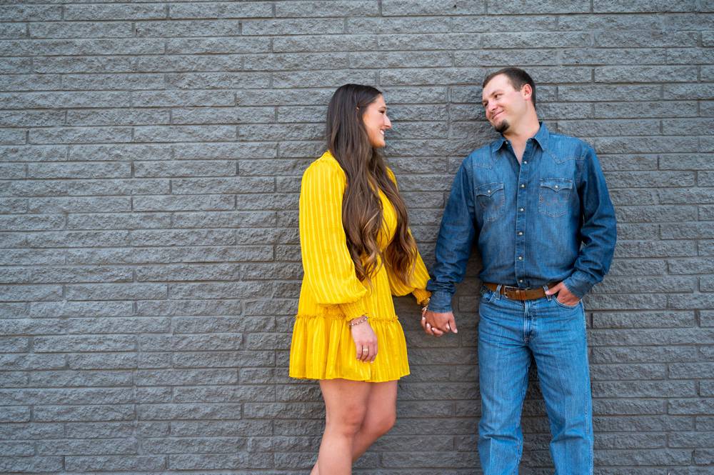 couple leaning against wall