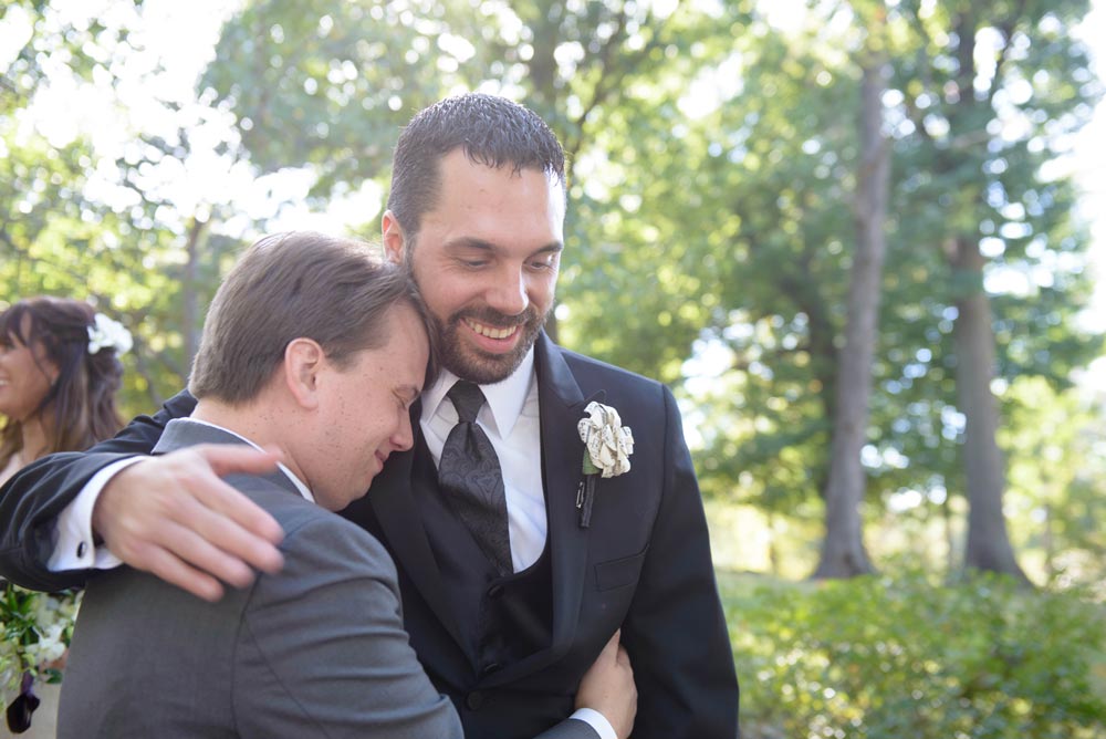 officiant hugging groom