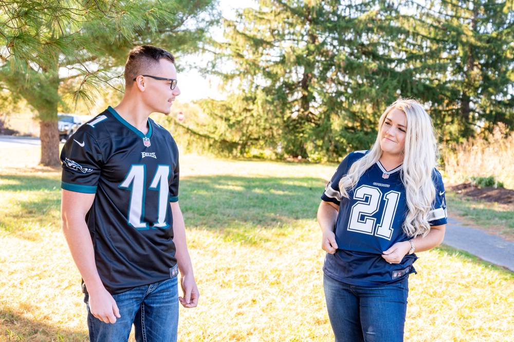 engagement photo with couples wearing NFL Jersey