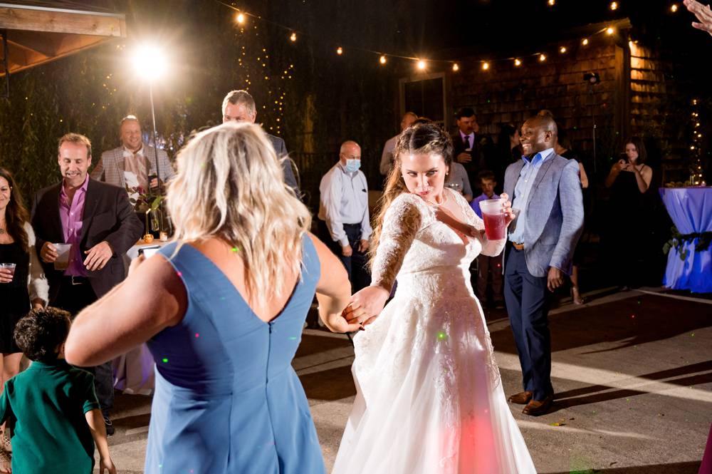bride dancing with friends at a wedding at the Stone Chapel at Matt Lane Farm