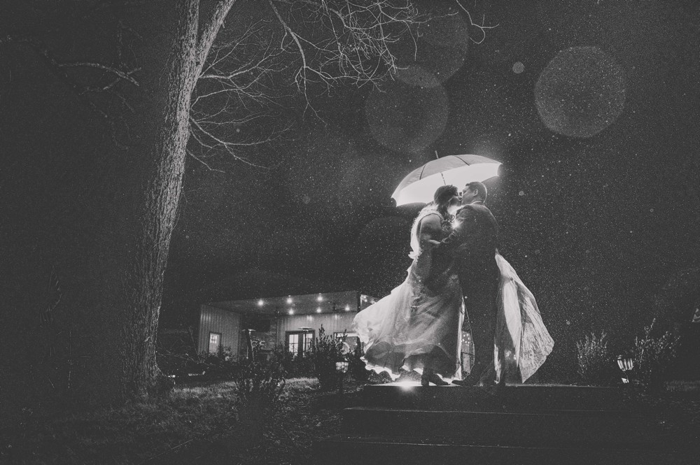 rainy wedding with couple and umbrella