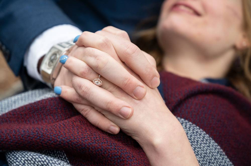 close up of engagement ring and cool watch