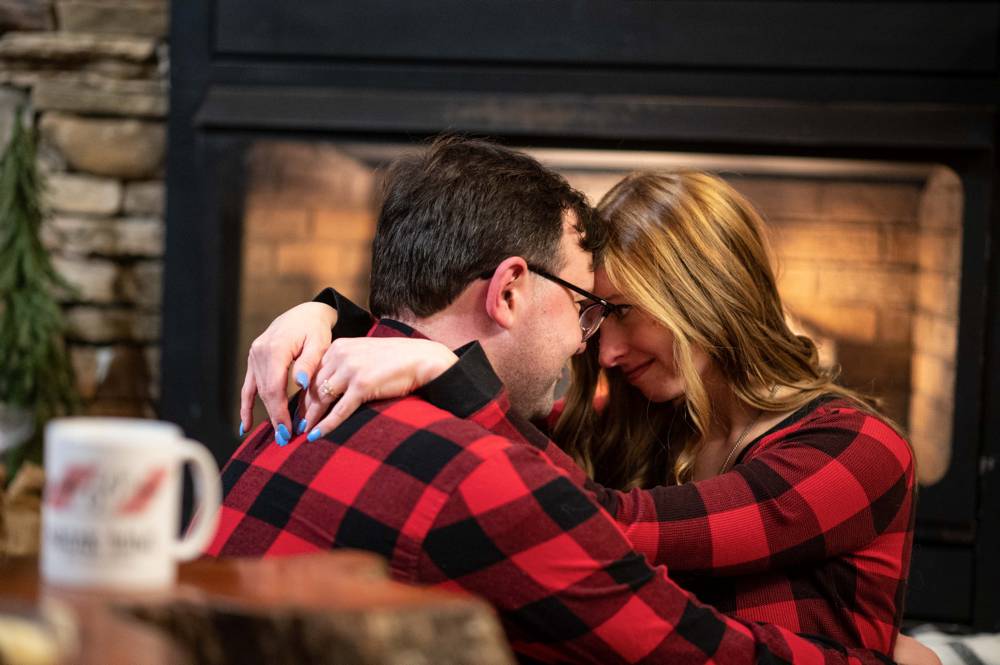 intimate winter themed engagement shoot in cabin in woods