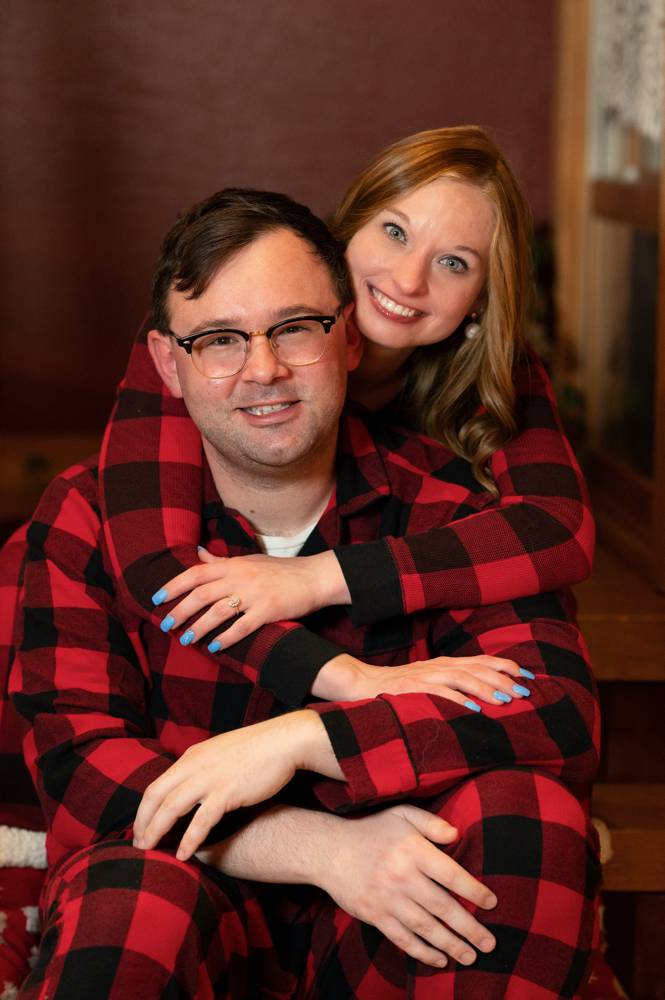 couple in plaid pajamas for engagement shoot
