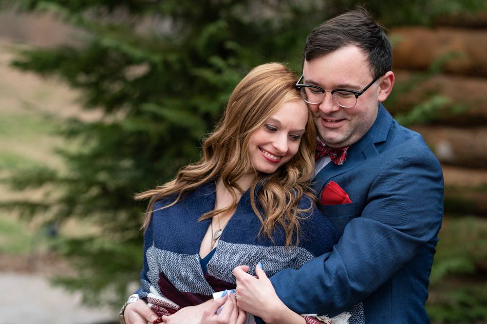 engaged couple in blue suit and blue dress