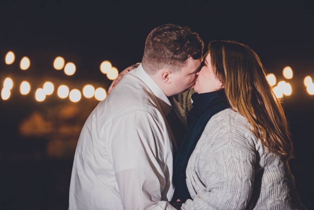 engagement photos with string lights in background