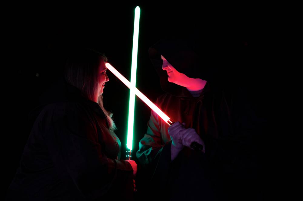 engagement photos with light sabers crossed