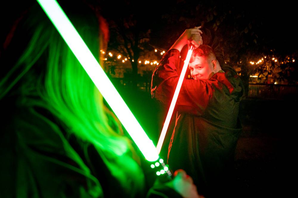 couple with red and green light sabers