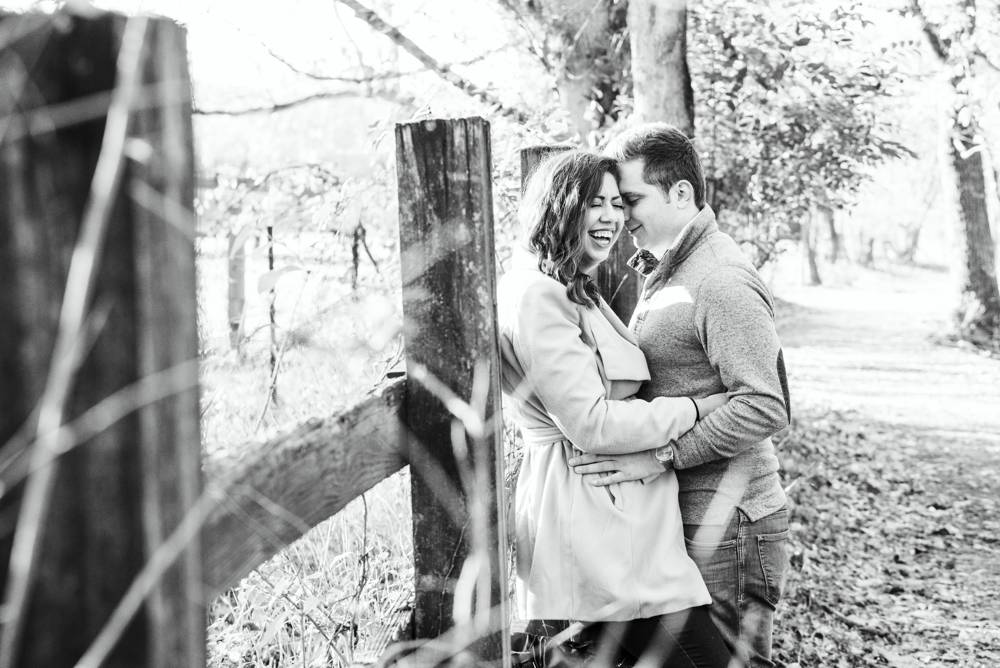 couple learning against fence at Queeny Park in St. Louis