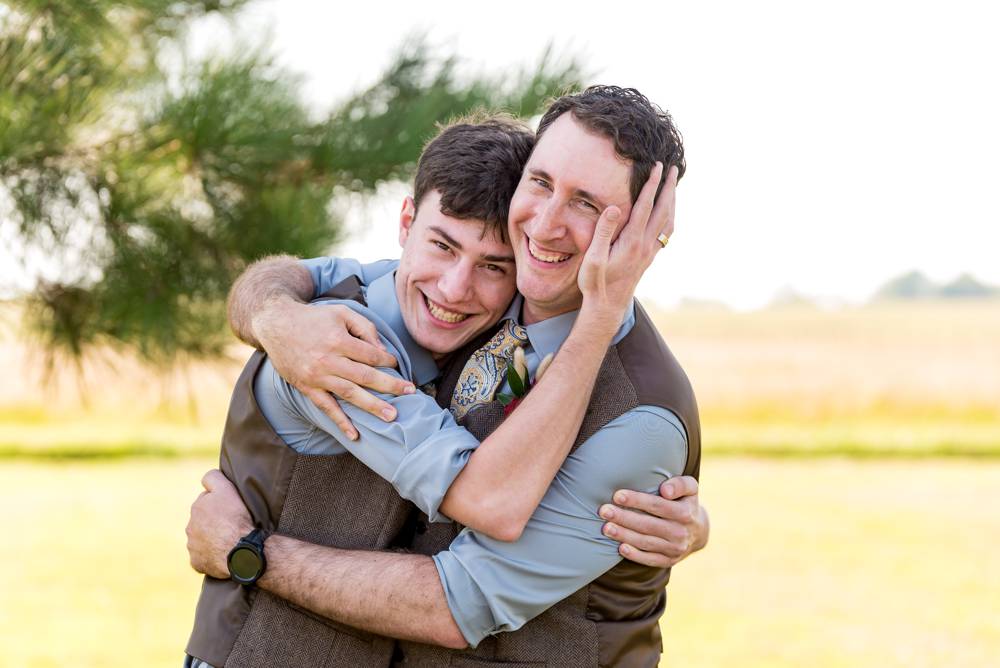 groom and brother hugging and goofing off