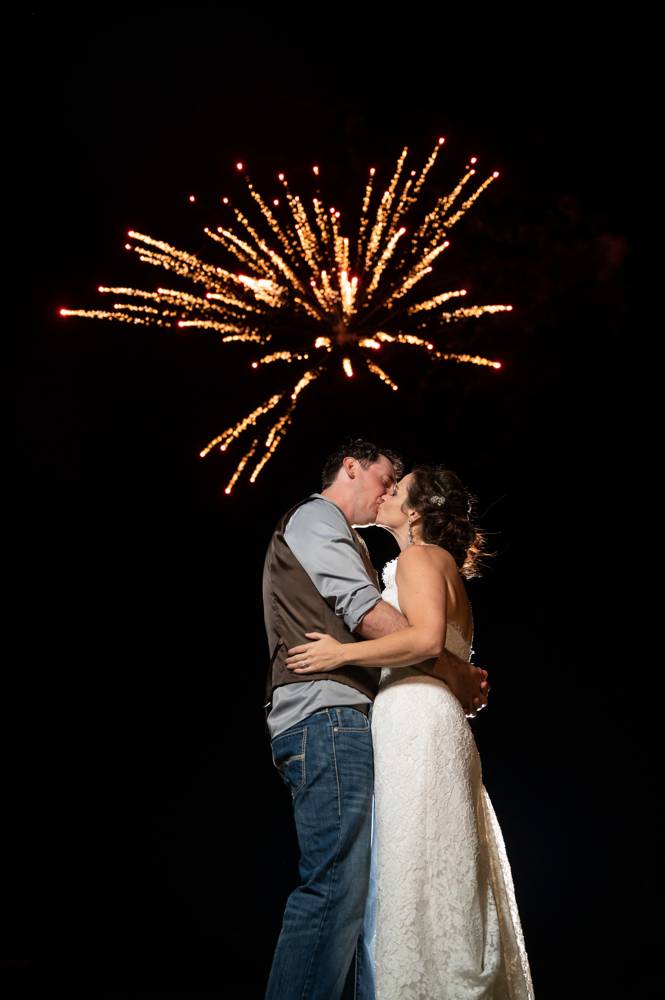 wedding couple with fireworks exploding in the sky