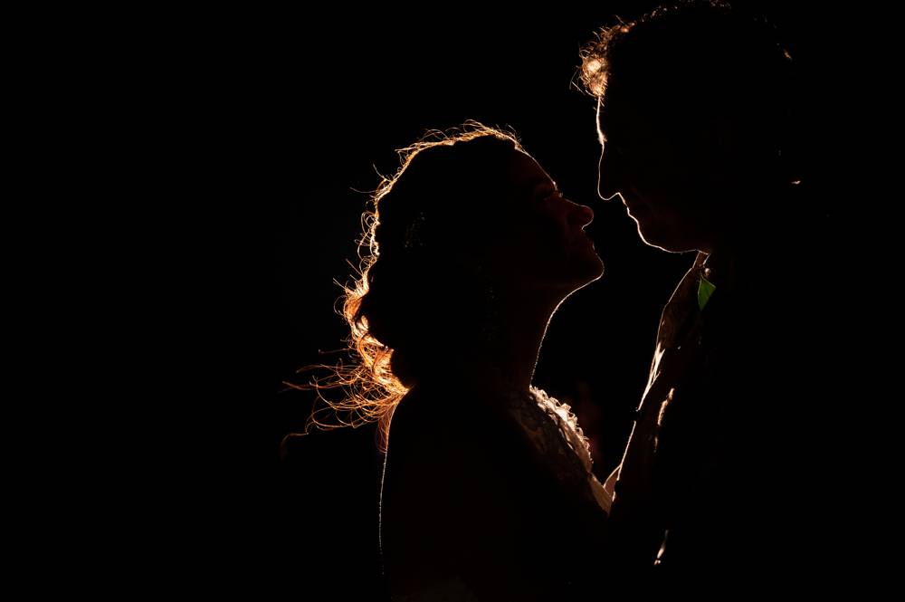 night time silhouette photo of bride and groom