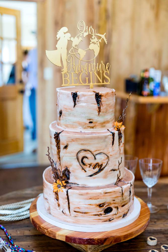 wedding cake with tree design and names carved
