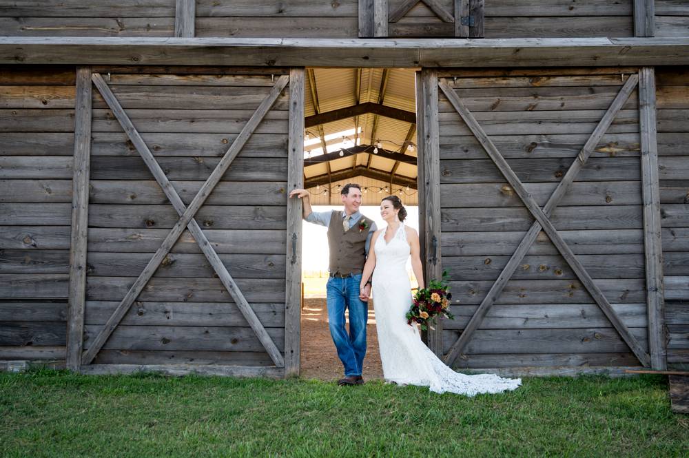 bride and groom in doorway of barn at The lodge at Rock Creek