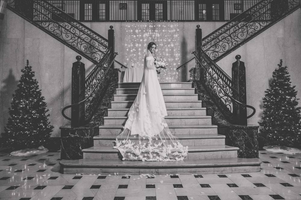 bride on staircase at Mayo Hotel in Tulsa black and white