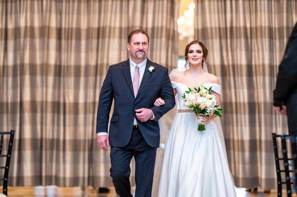 bride walking down the aisle at Mayo Hotel