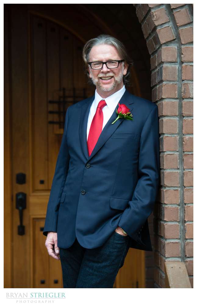 groom portrait outside of stone chapel