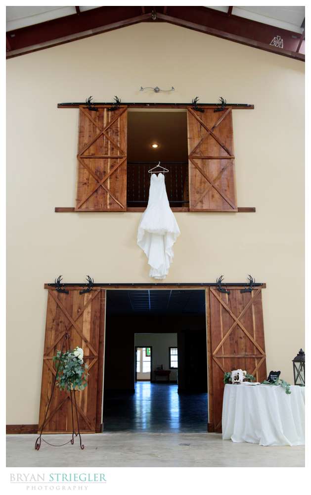 wedding dress hanging off balcony at Rockford Grange