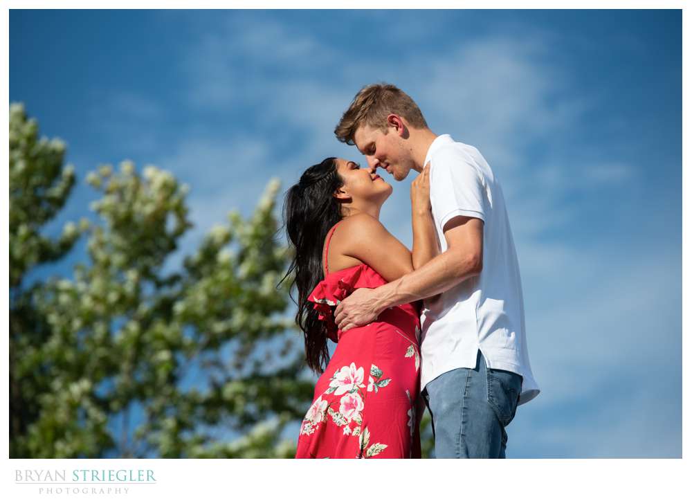 engagement photo with blue skies