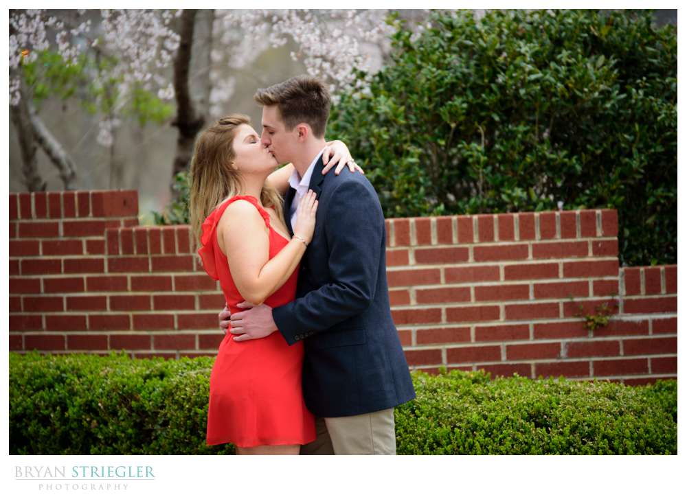 engagement photos in front of brick wall