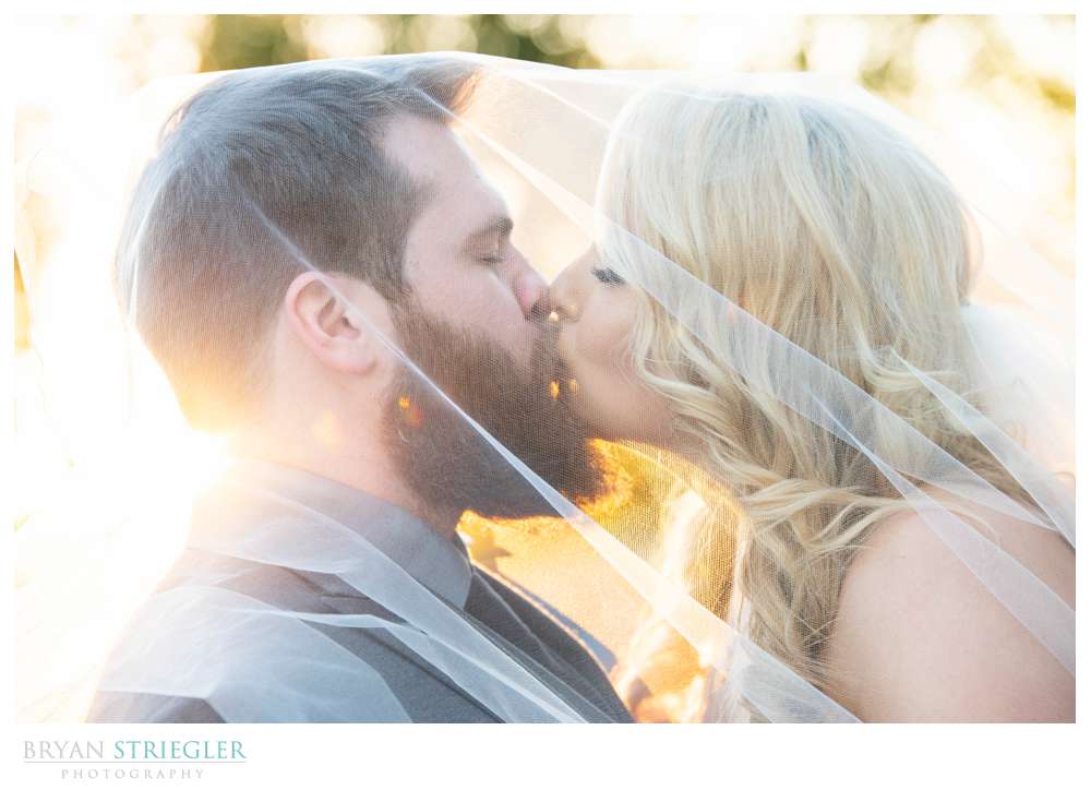 couple kissing under veil