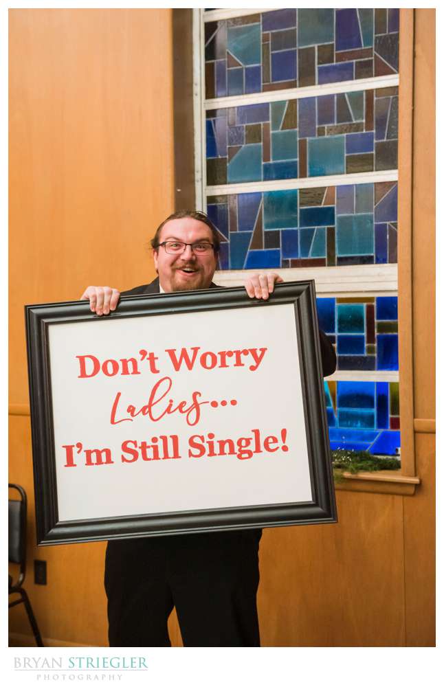 groomsmen with funny sign