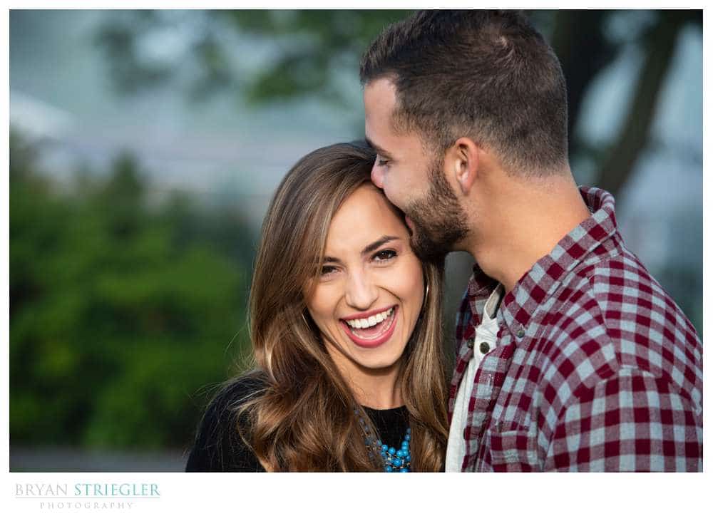 engagement photo kissing forehead