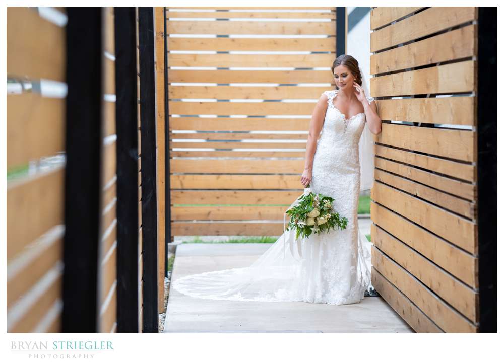 bride leaning against wall