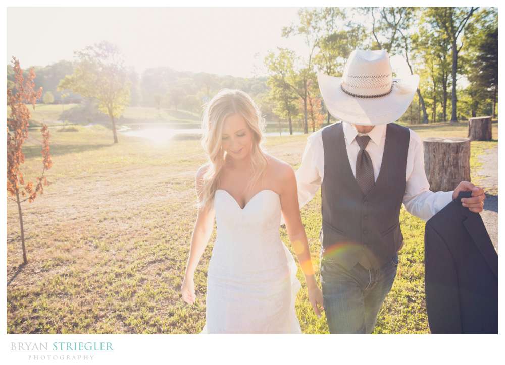 bride and groom walking with backlight