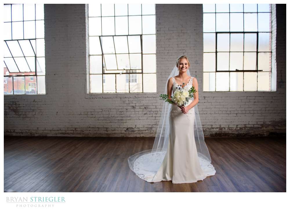 bridal portrait in front of large windows