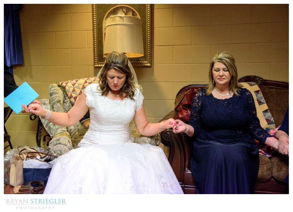 bride praying with family