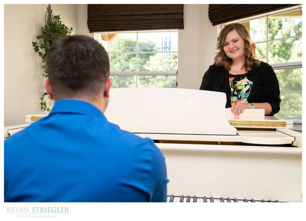 engagement photo standing by piano