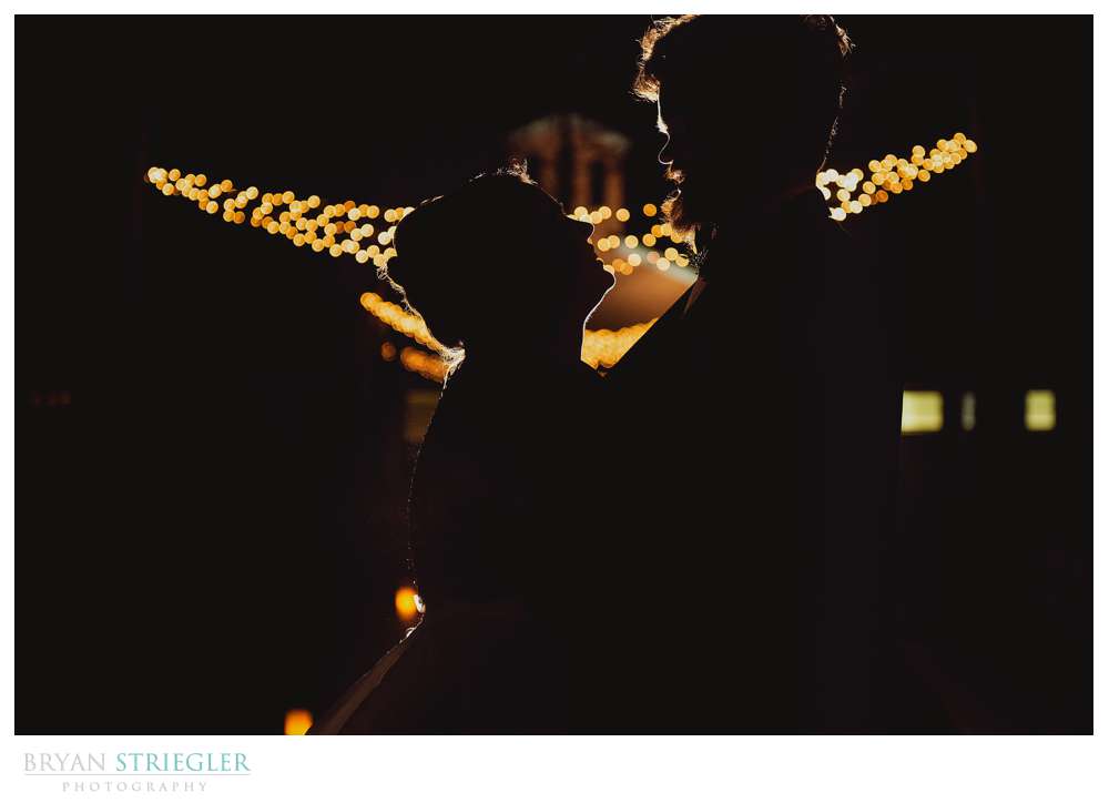 silhouette of wedding couple with christmas lights