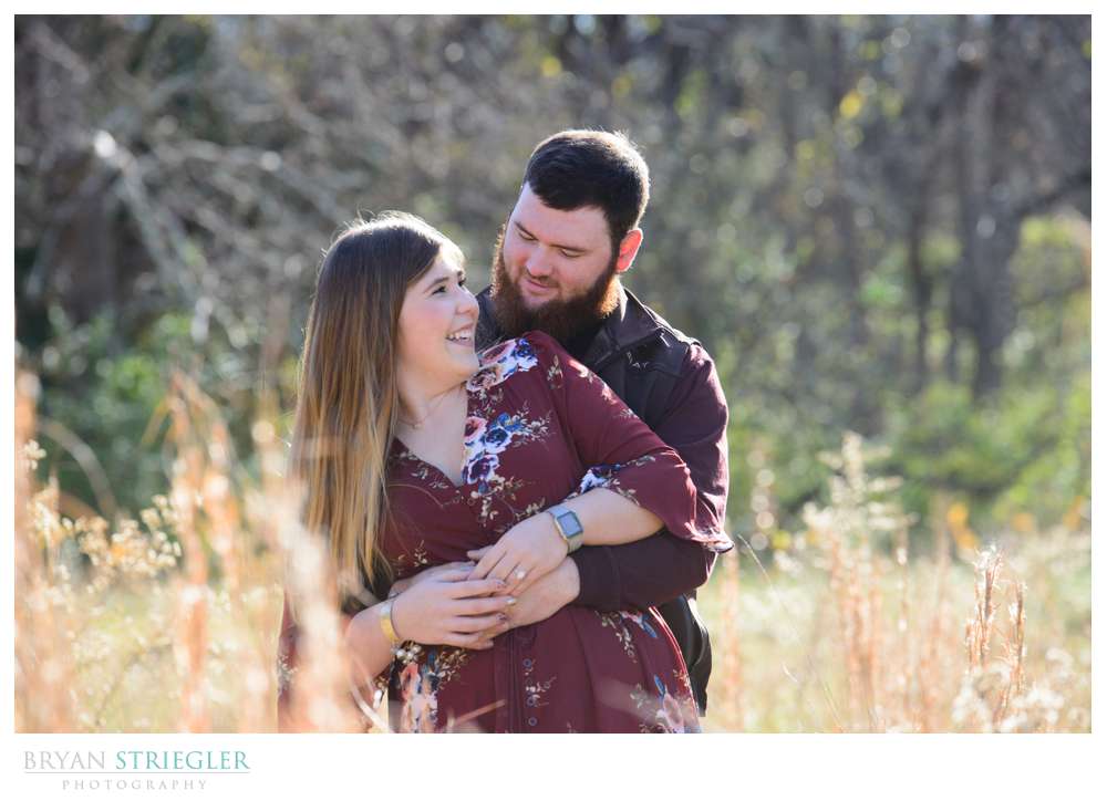 couple in a field with high grass