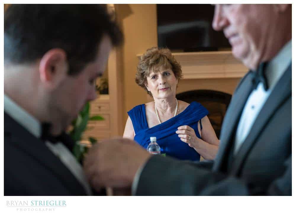 mother watching groom and husband