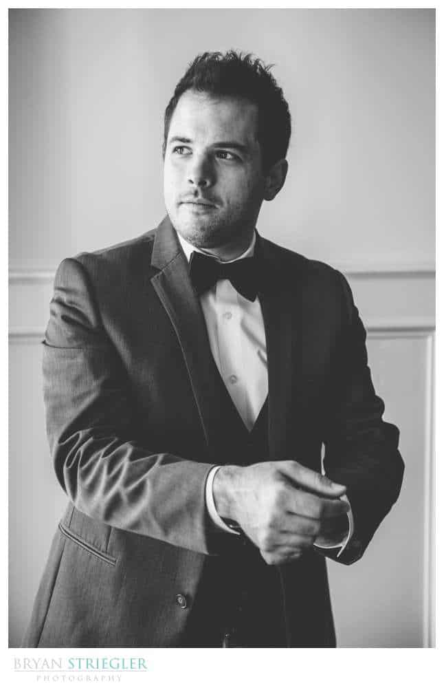 groom getting ready black and white