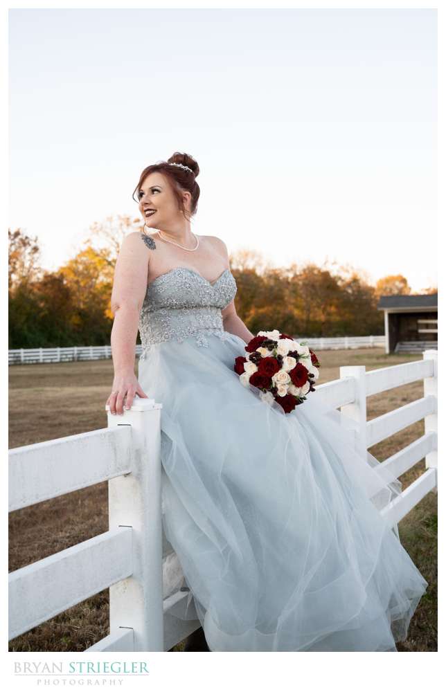 bride sitting on fence