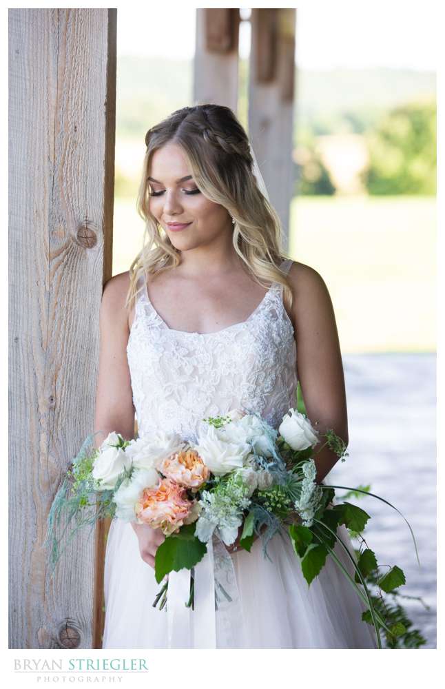 bride leaning against column