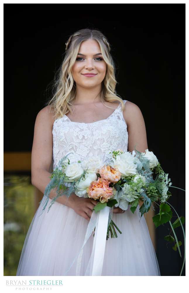 bride on porch of Willow Brooke Farm venue