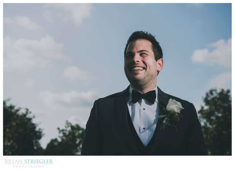 groom portrait with blue sky