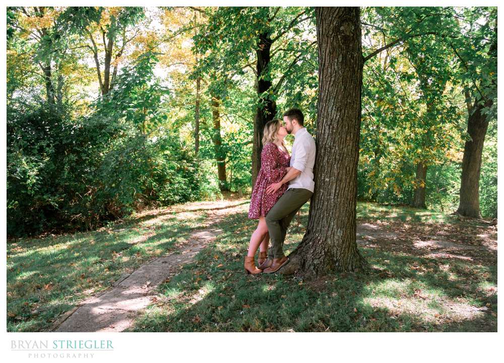 leaning against a tree engagement photo