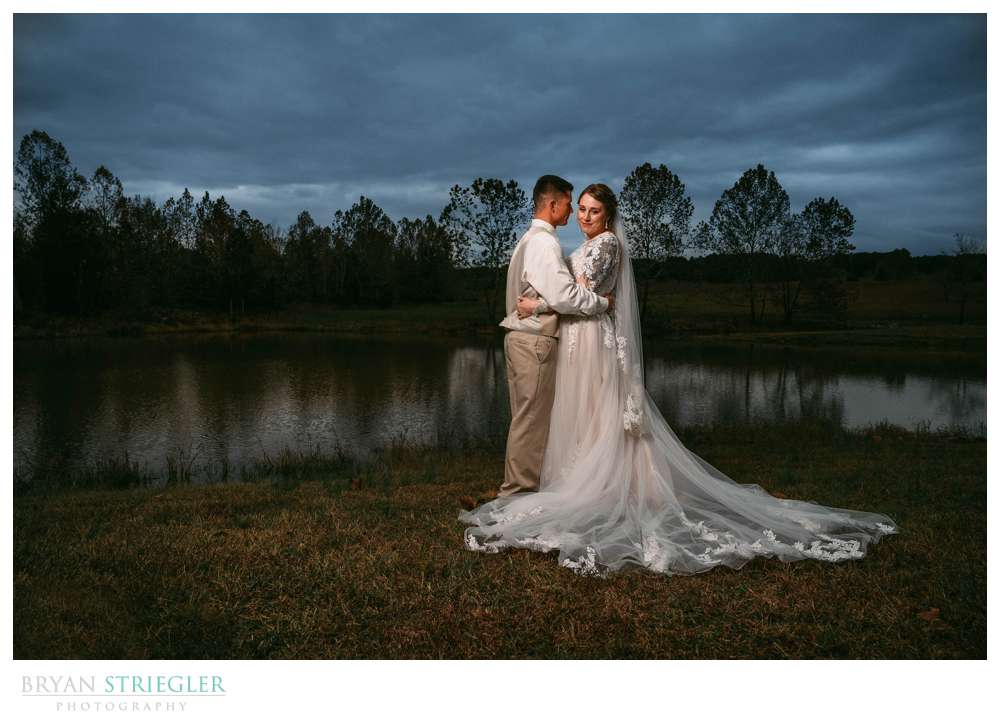 dramatic wedding portrait by pond