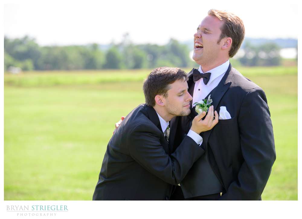 groomsman smelling flower