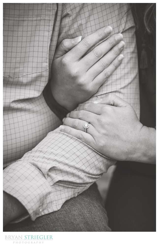 close up of couples arms and wedding ring
